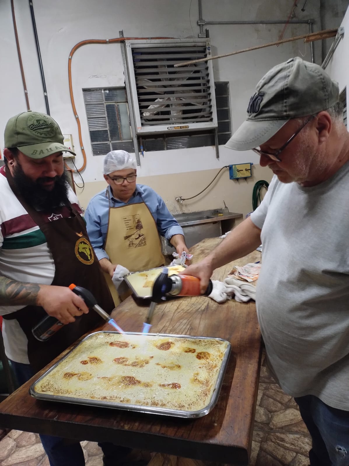 Lasanha sendo finalizada na cozinha